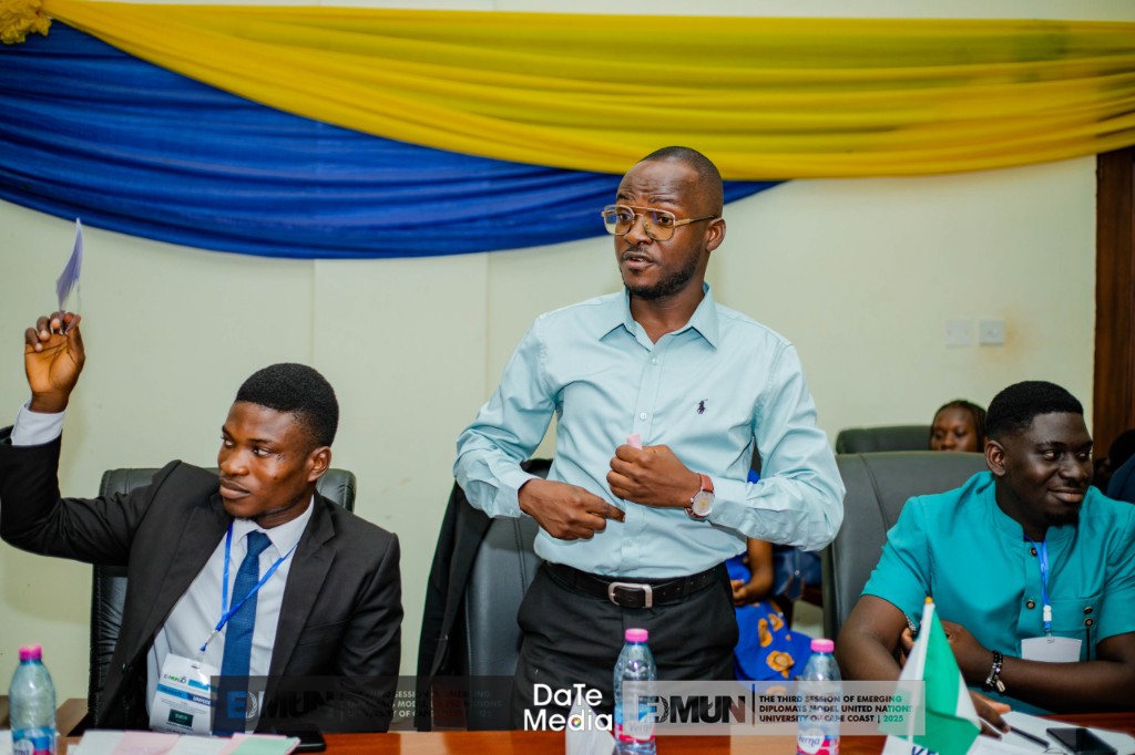 Three delegates at EDMUN session — voting and discussion, University of Cape Coast 2025