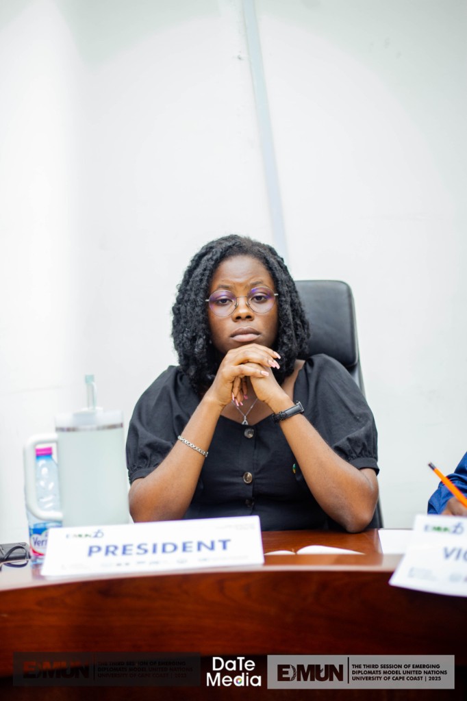 EDMUN president seated at desk with placard, University of Cape Coast 2023