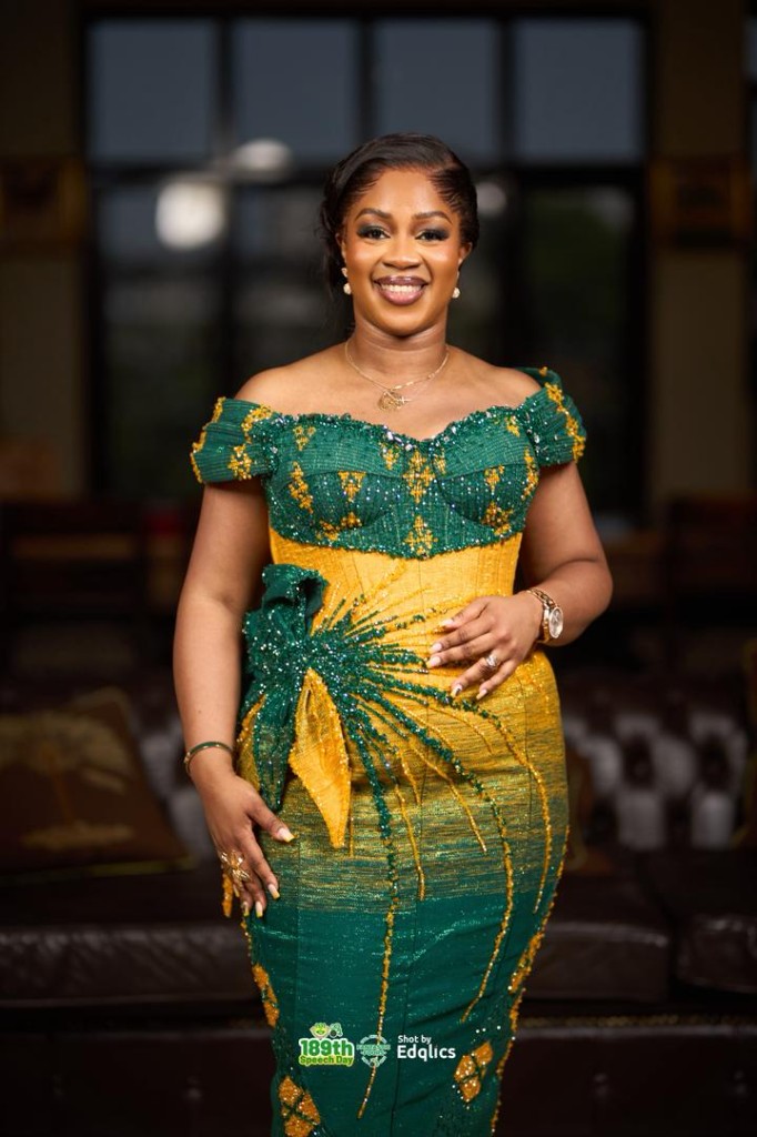 Woman in custom emerald and gold off-the-shoulder gown with beadwork, Speech Day