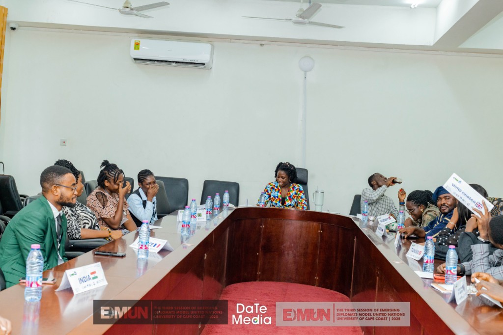 EDMUN Model UN session around a U-shaped table with country placards, 2023