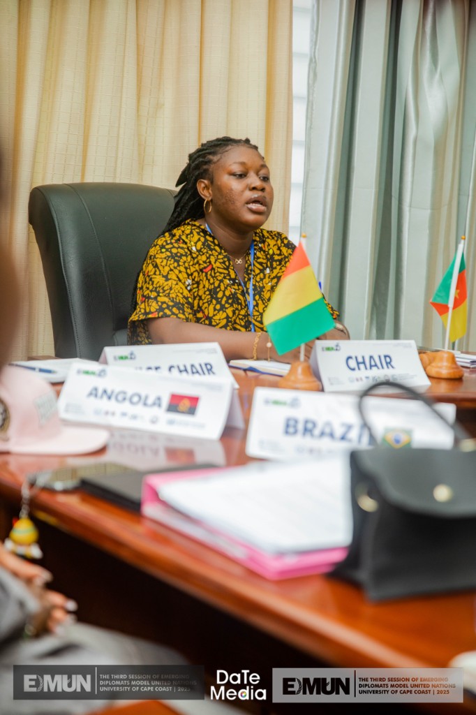 Committee chair at EDMUN with Angola and Brazil placards and desk flags, 2023