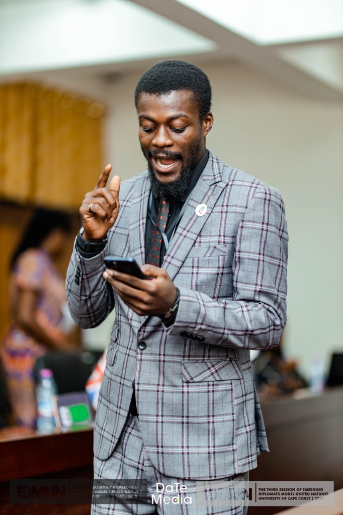Delegate in grey windowpane suit during EDMUN, University of Cape Coast 2023