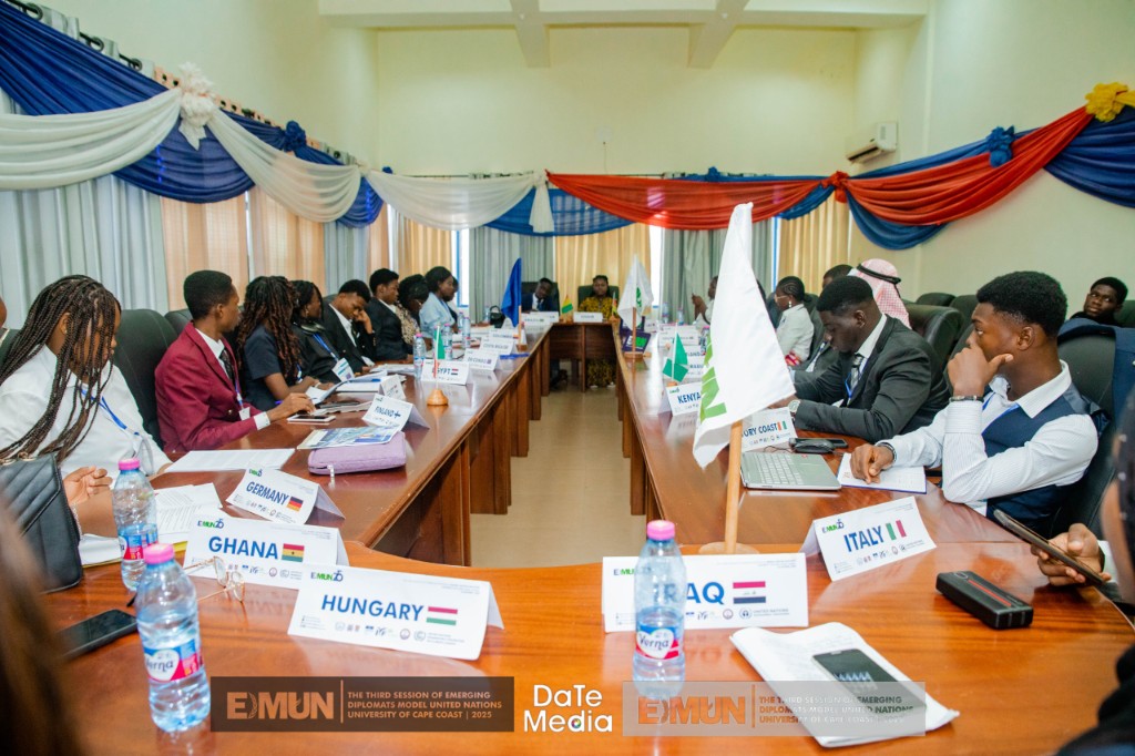 Wide view of EDMUN session with country placards and formal attire, 2023