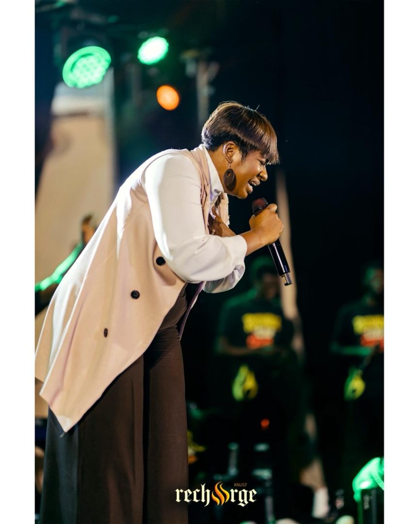Singer performing into a microphone on stage
